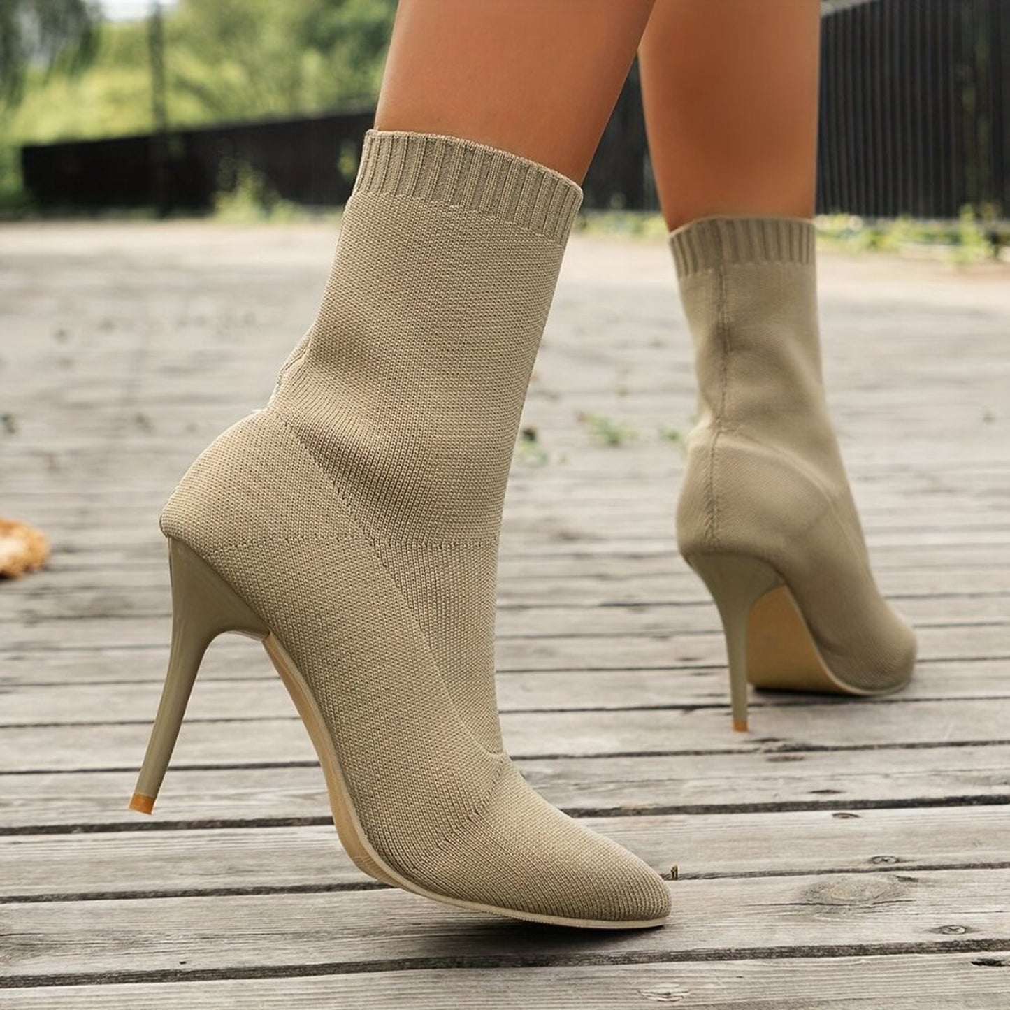Beige sock boots on a wooden floor