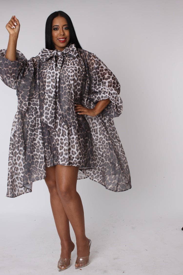 Woman wearing a leopard print dress on a white background