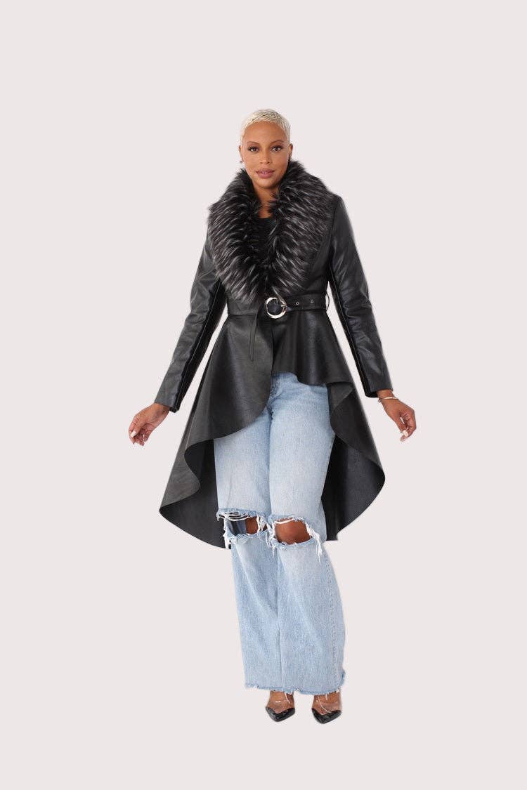 Woman wearing a long black coat with a fur collar on a white background