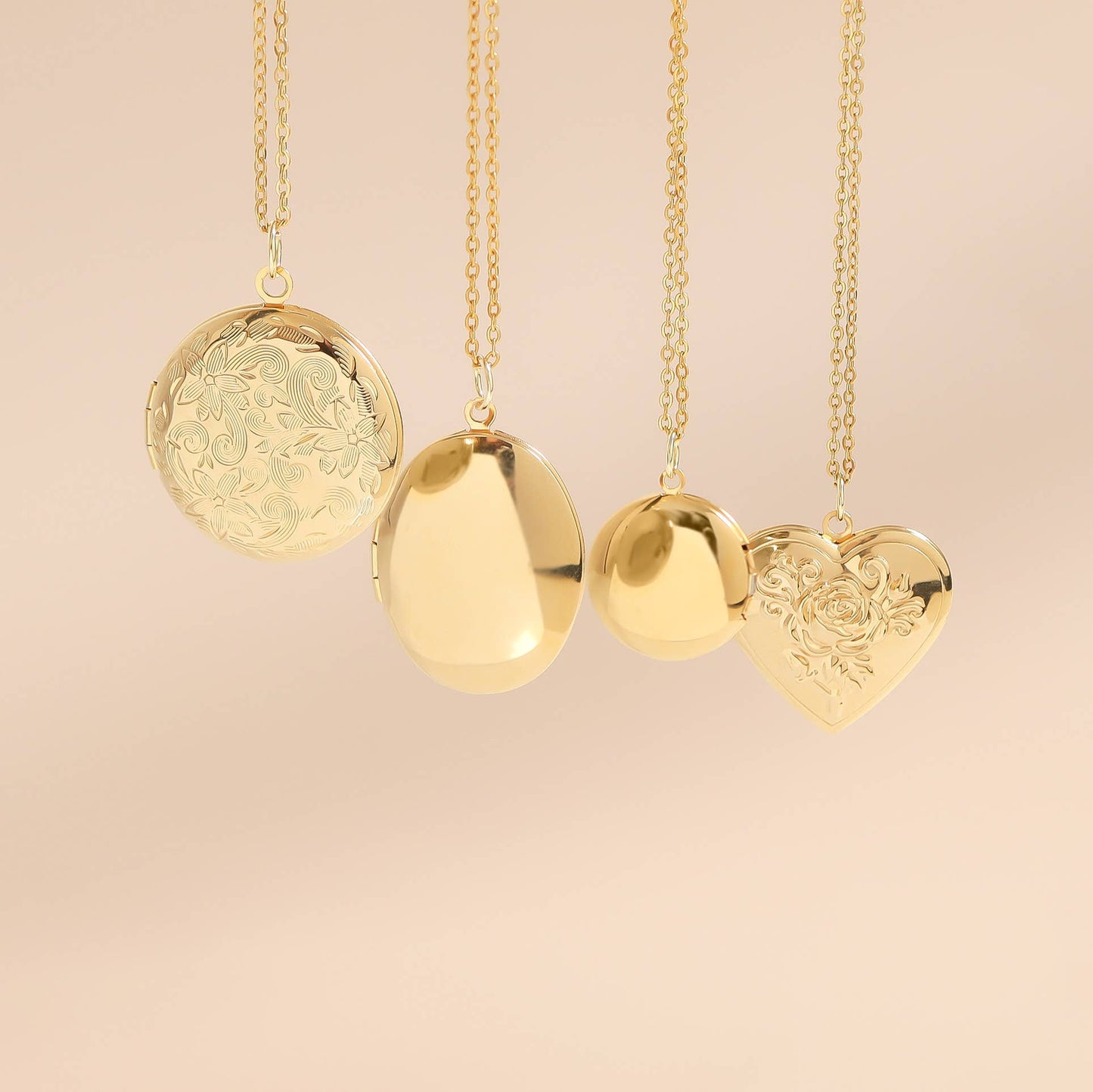 Gold necklaces with various pendants on a beige background