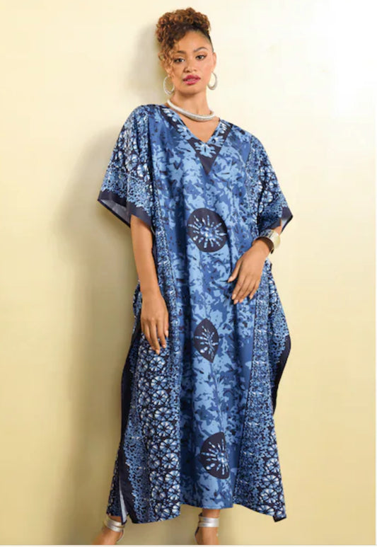 Woman wearing a blue patterned dress against a beige background