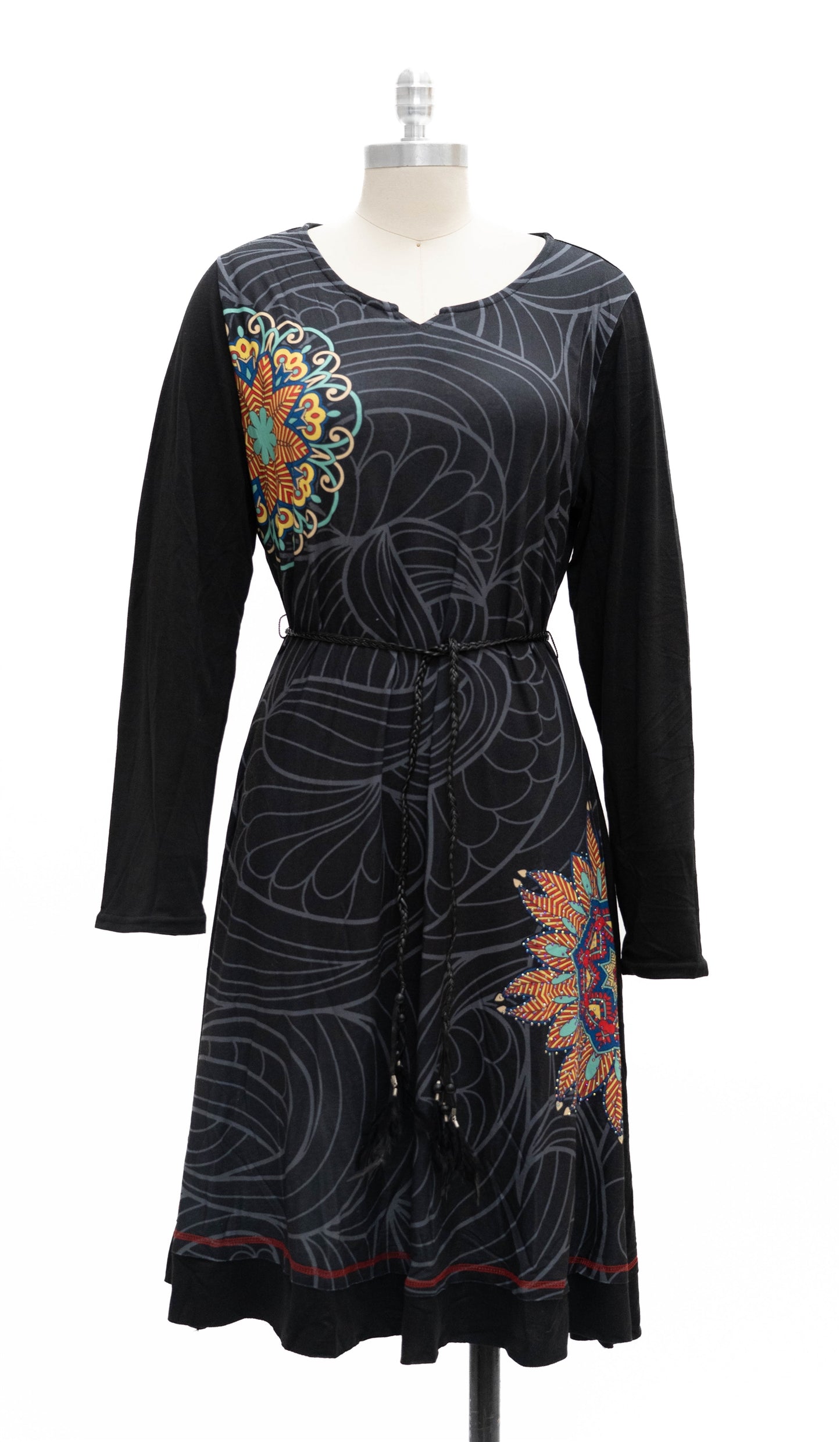 Black dress with colorful floral patterns on a mannequin against a white background