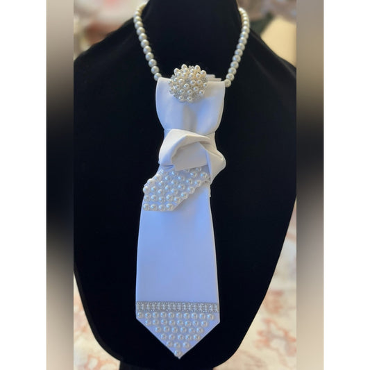 Decorative tie with pearls on a black stand
