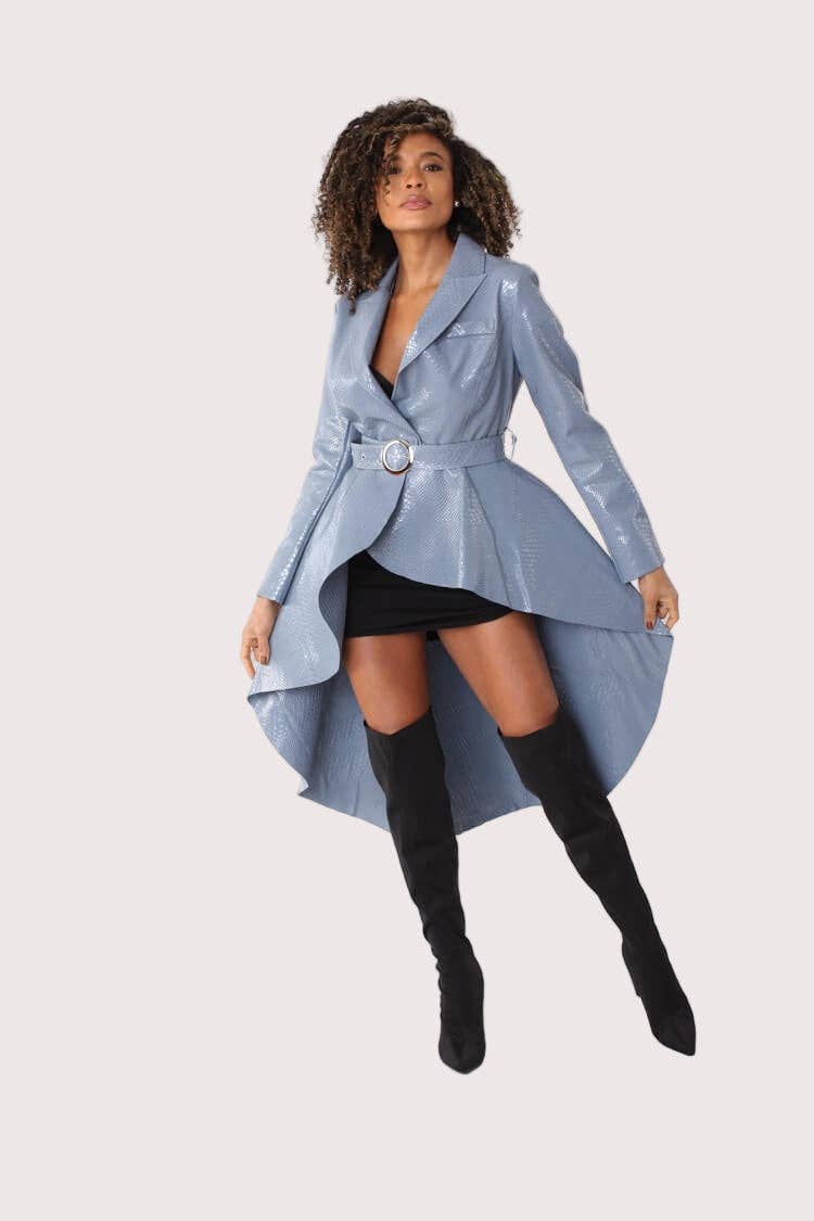 Woman wearing a light blue coat with a belt on a white background