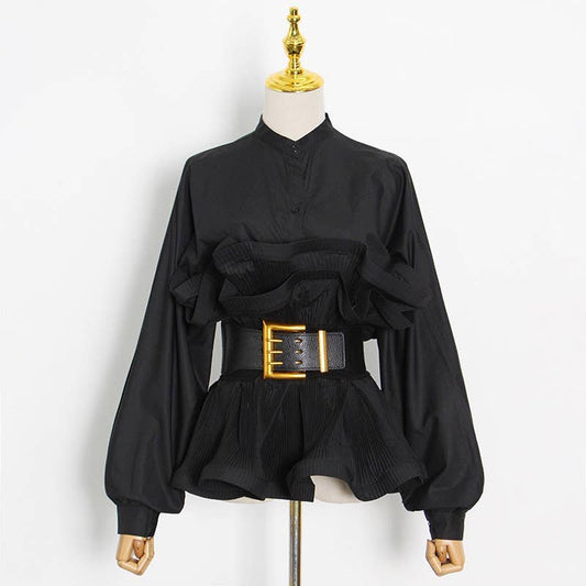Black blouse with a gold belt on a mannequin against a white background