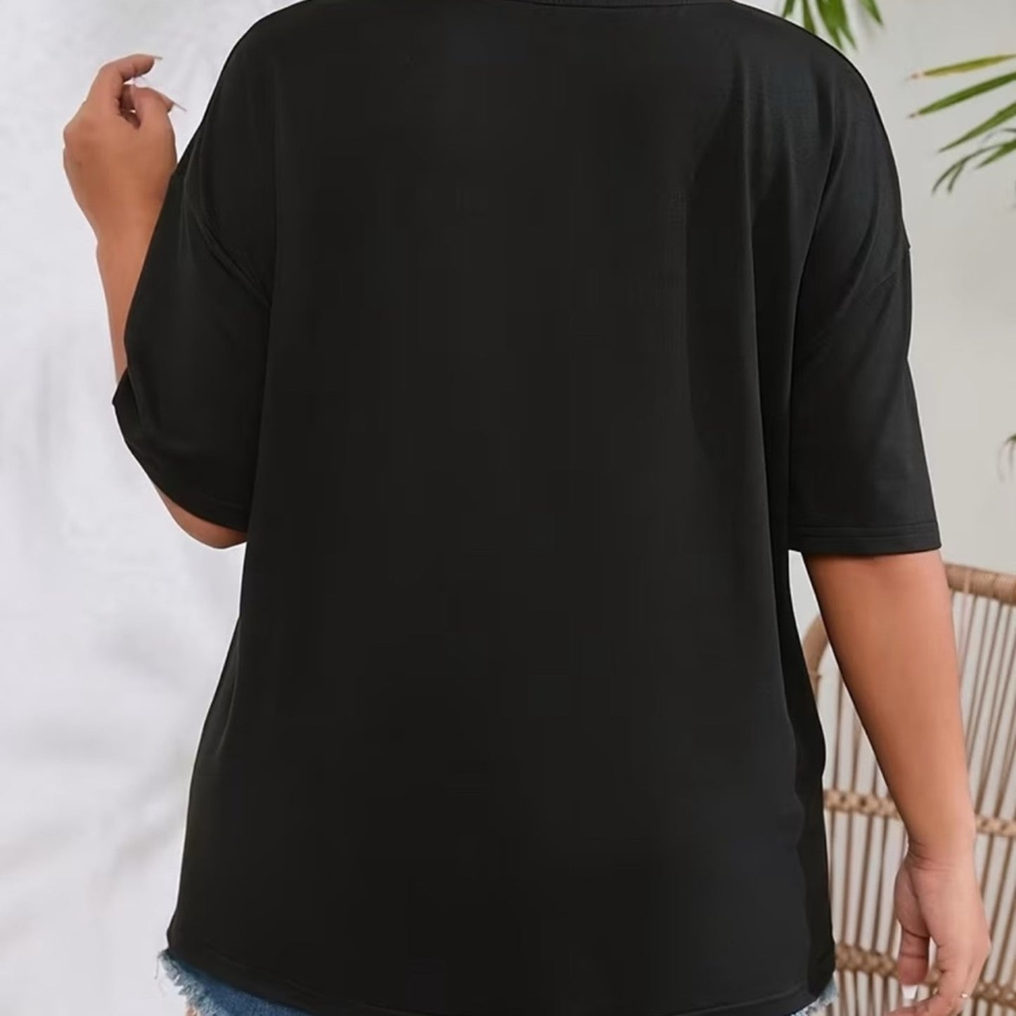 Black top worn by a person with a white background