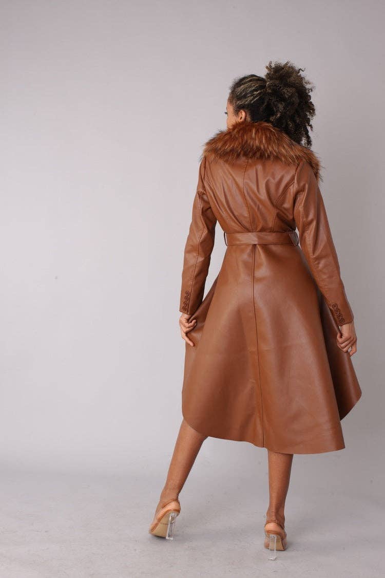 Person wearing a brown leather coat with fur collar on a plain background