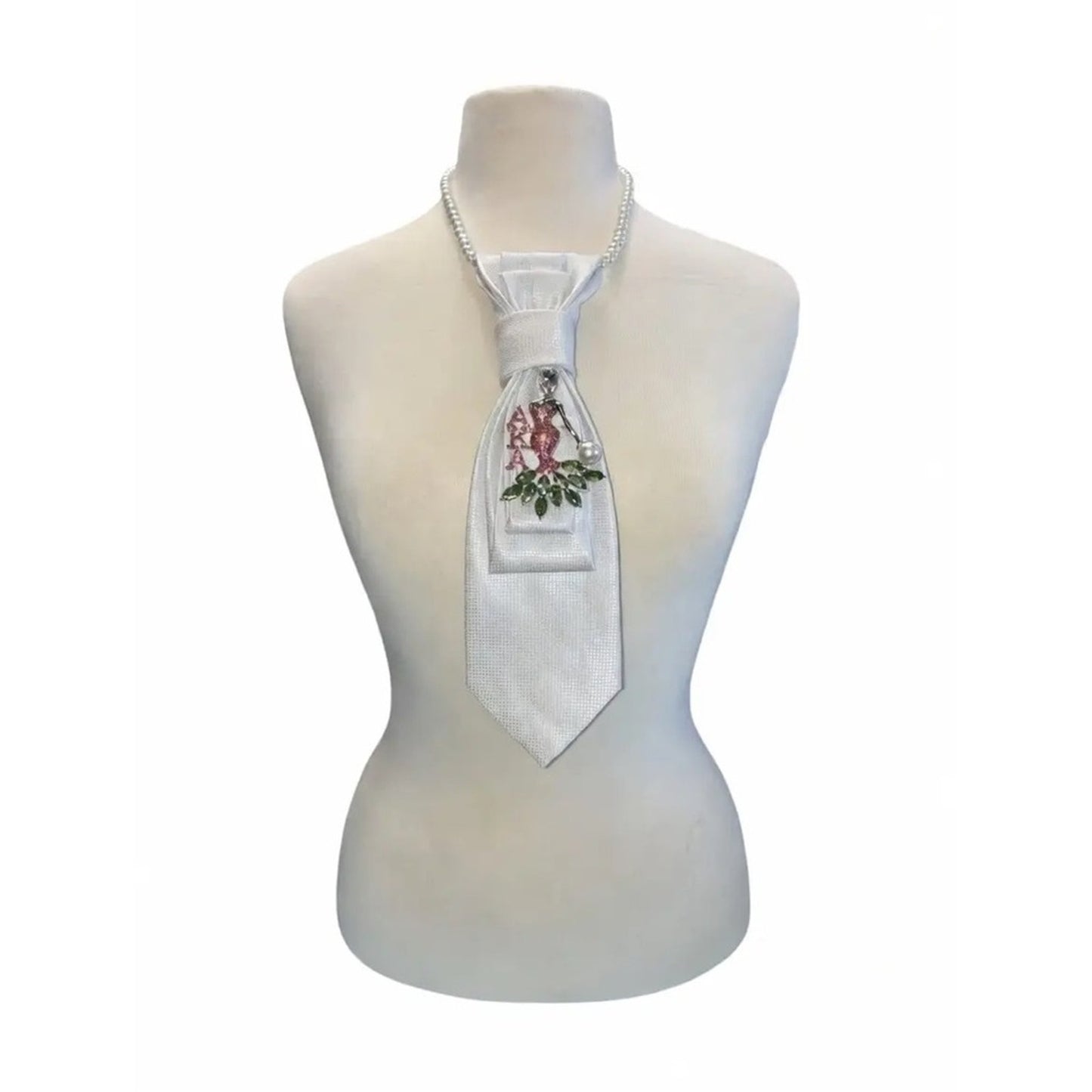 White tie with decorative elements on a mannequin torso against a white background
