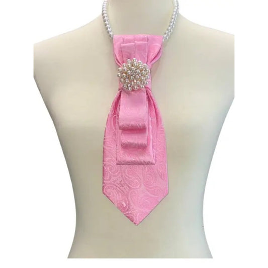 Mannequin wearing a pink paisley tie with a decorative brooch on a white background