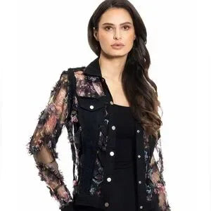 Woman wearing a floral lace jacket over a black top on a white background