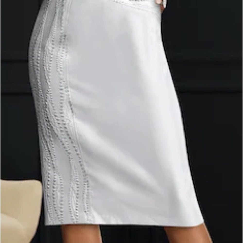 White skirt with lace trim on a black background