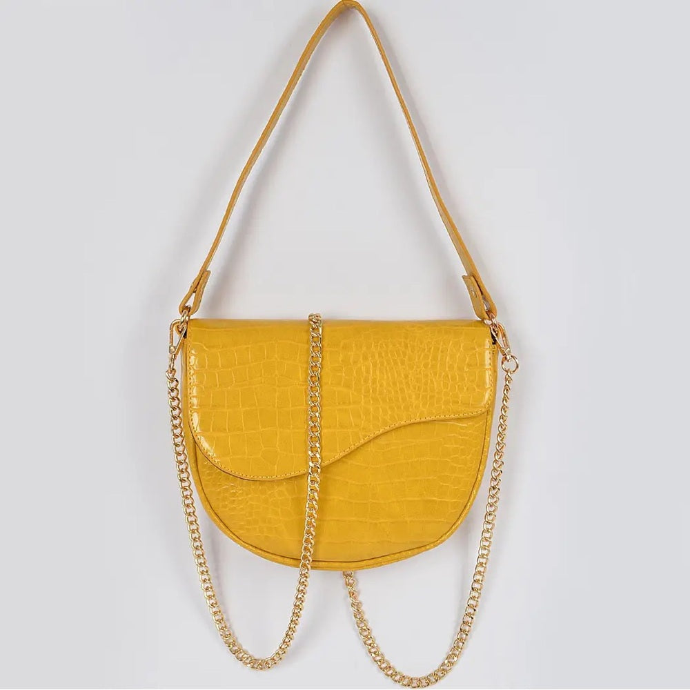 Yellow handbag with a gold chain on a light gray background