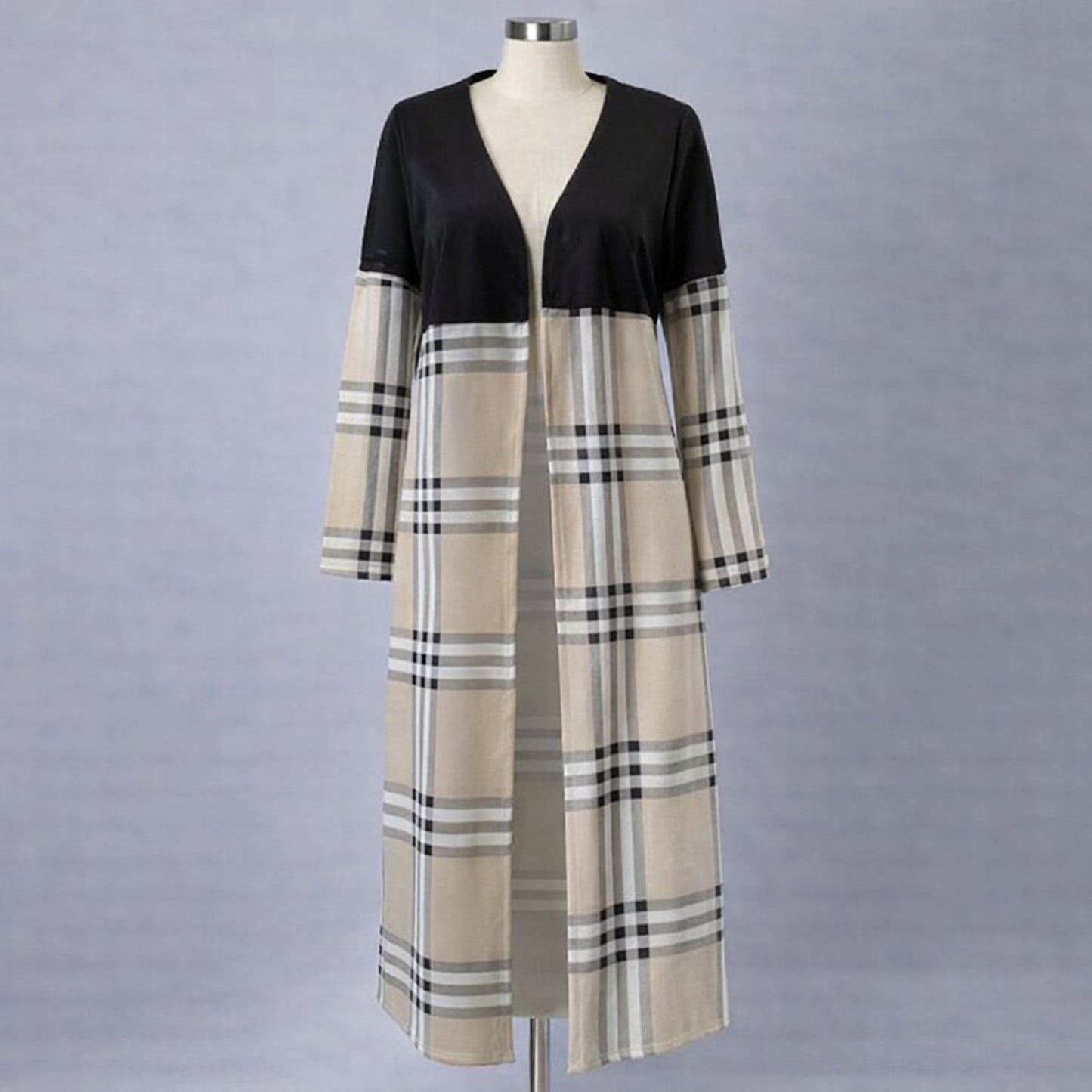 Mannequin wearing a black and beige checkered dress on a gray background