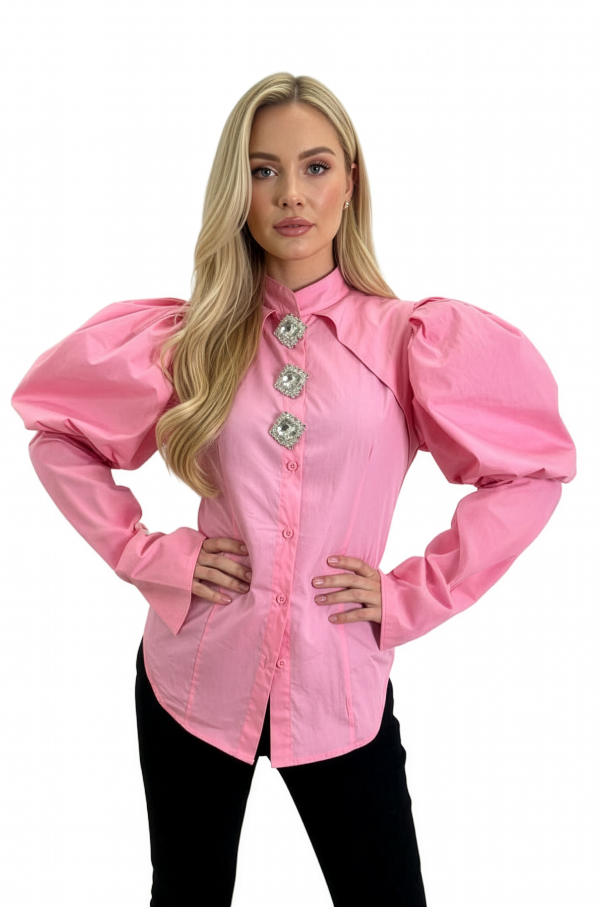 Woman wearing a pink blouse with large buttons and puffed sleeves on a white background
