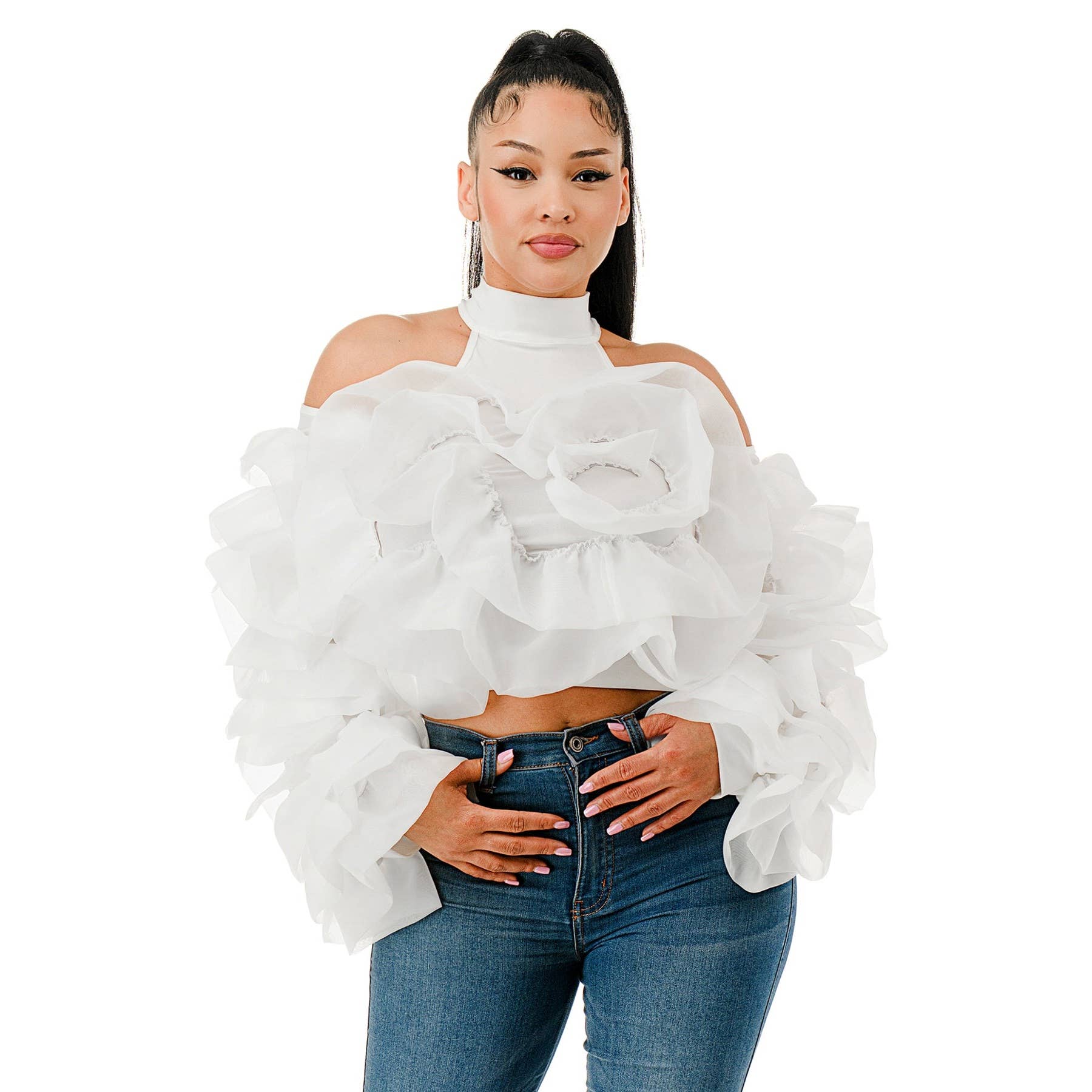 Woman wearing a white ruffled top and blue jeans on a white background
