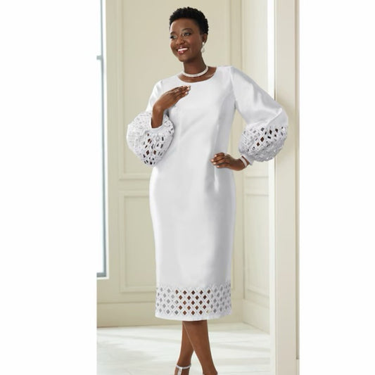 Woman wearing a white dress with cut-out details in a neutral setting