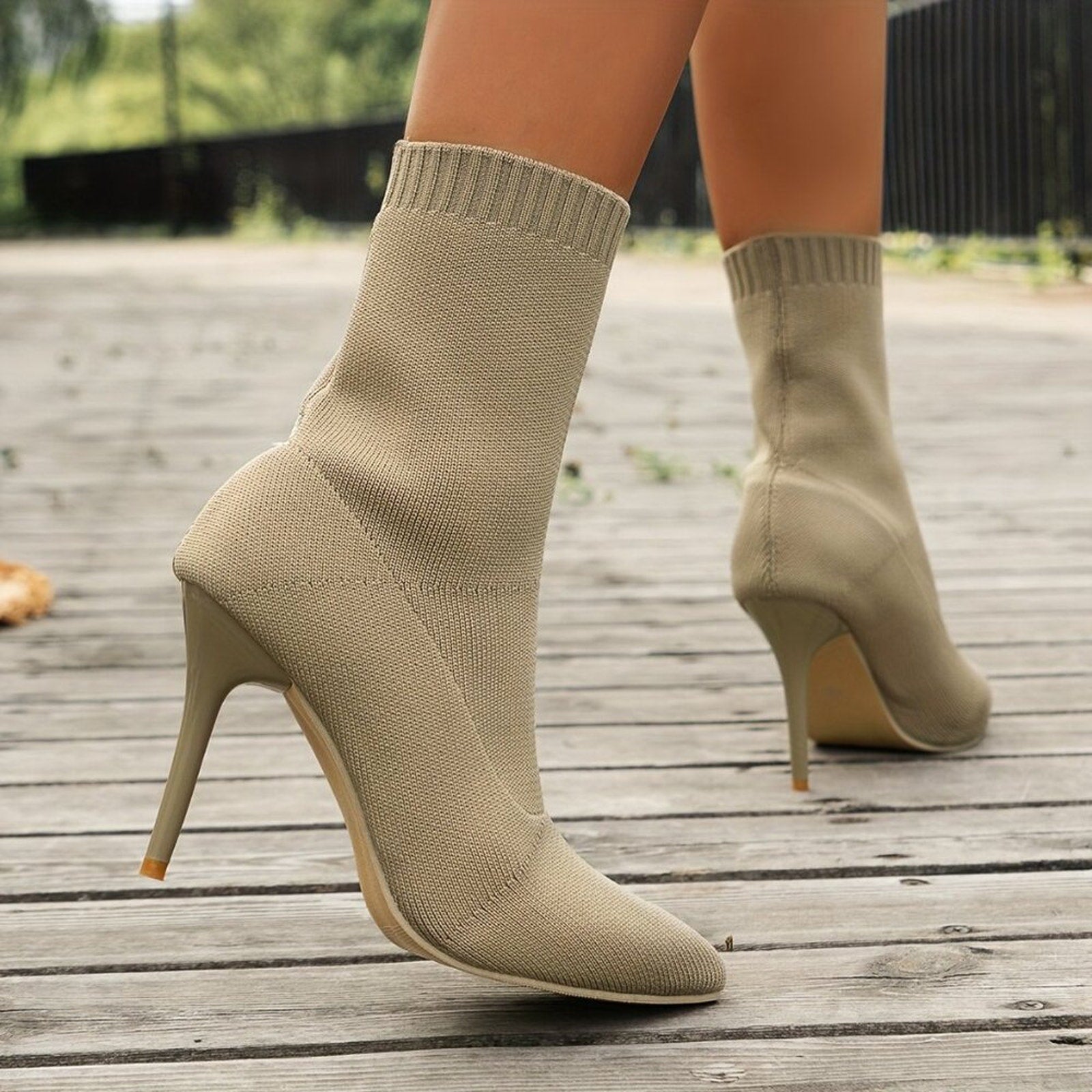 Beige sock boots on a wooden floor