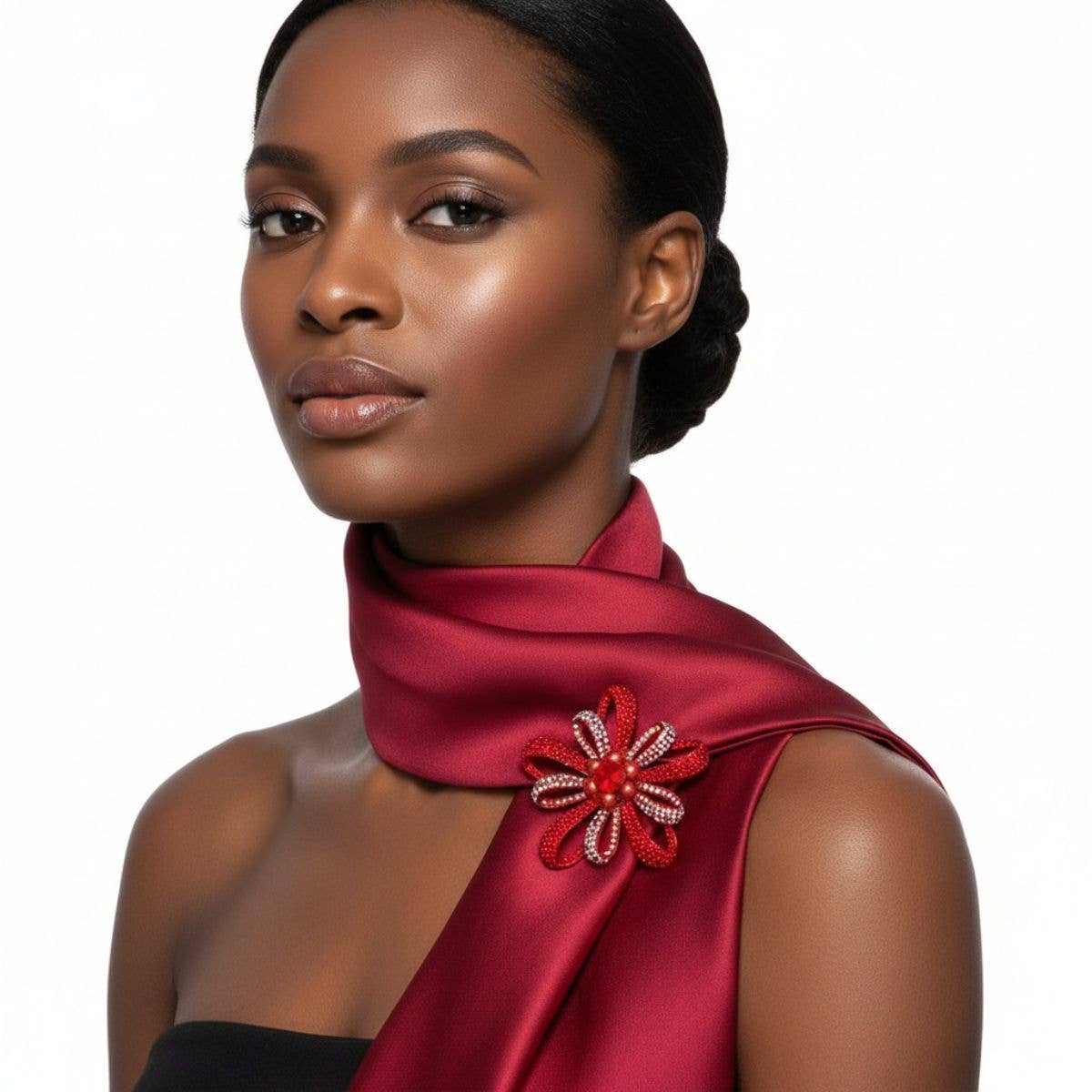Woman wearing a red scarf with a decorative brooch on a white background