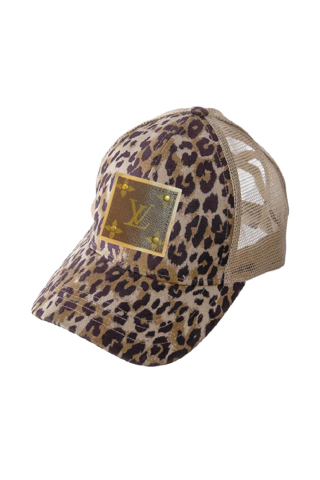 Leopard print cap with a gold patch on a white background