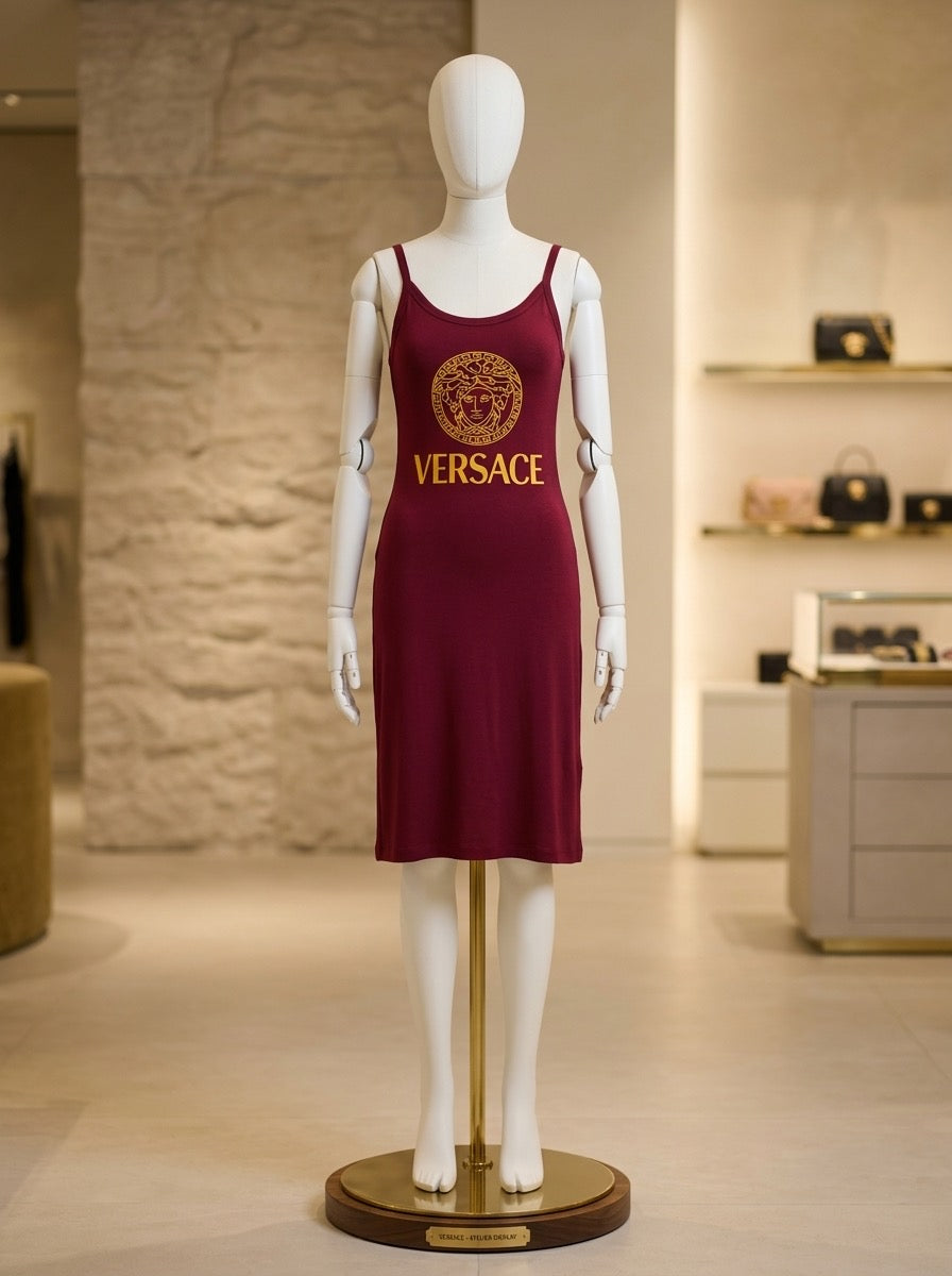 Mannequin wearing a burgundy Versace dress in a store setting