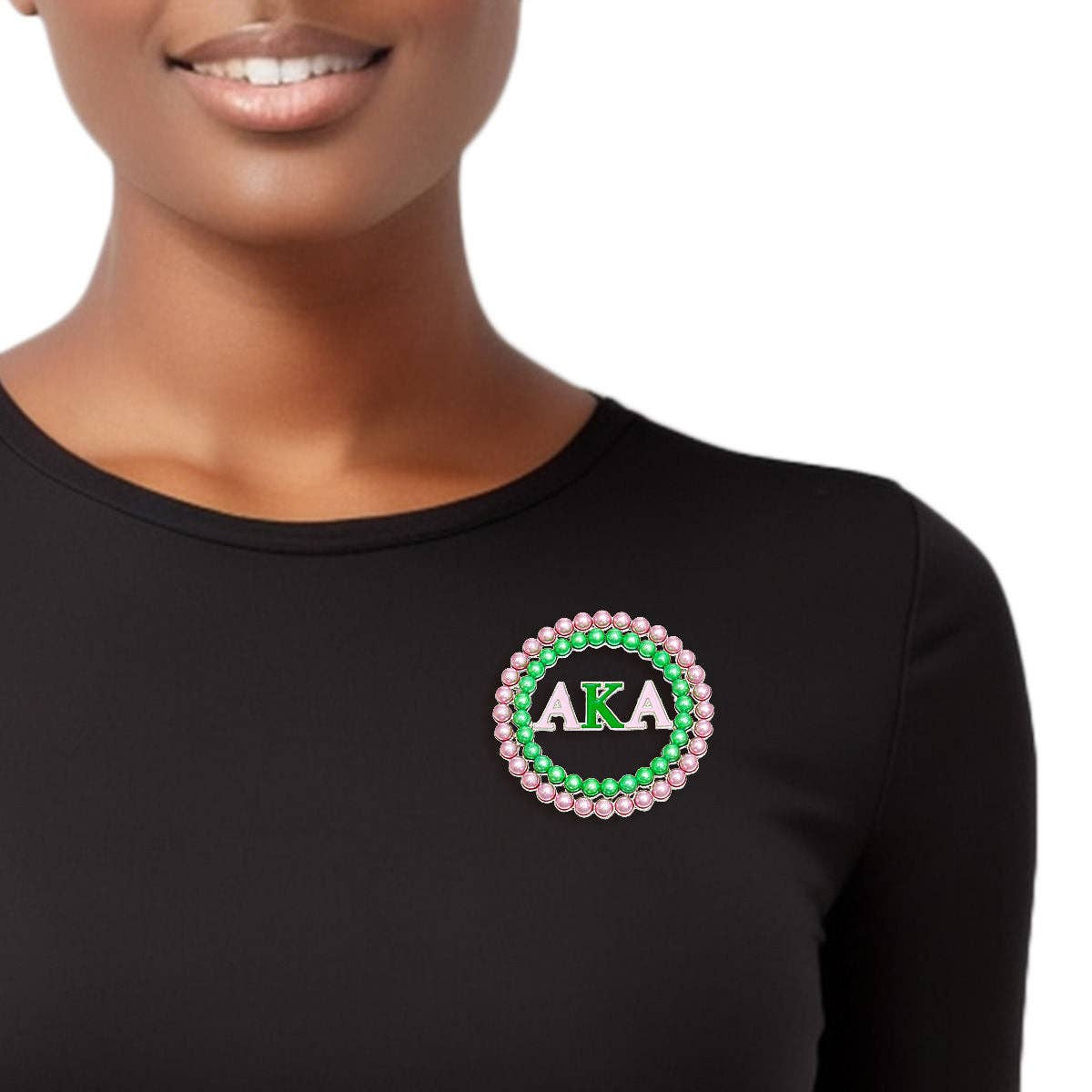 Black long-sleeve shirt with AKA logo worn by a person on a white background