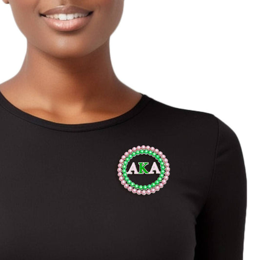 Black long-sleeve shirt with AKA logo worn by a person on a white background