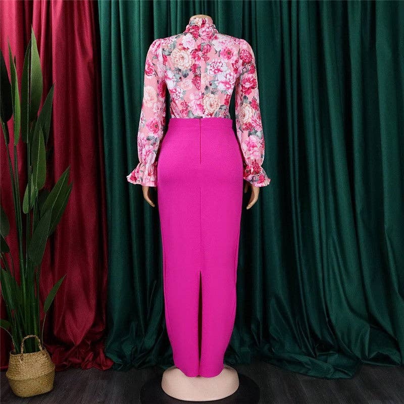 Mannequin wearing a floral top and pink pants against a green curtain background