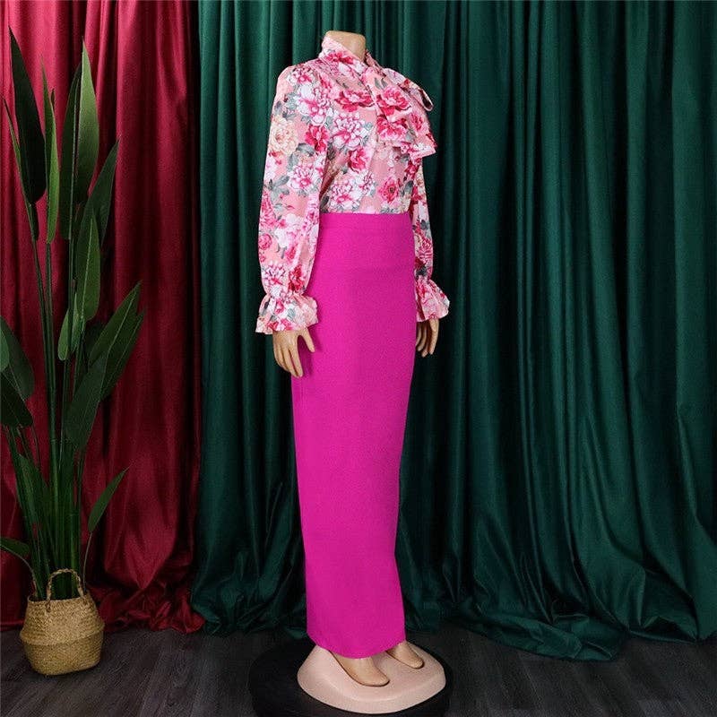 Mannequin wearing a pink floral top and pink skirt against a green curtain background