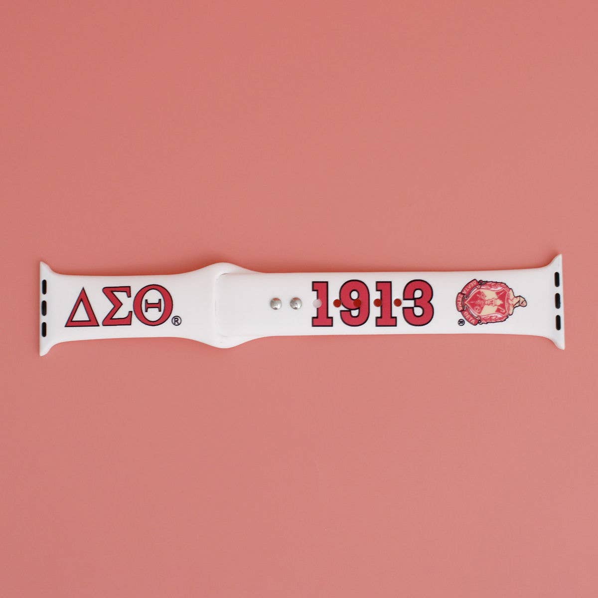 White bracelet with red text and symbols on a pink background