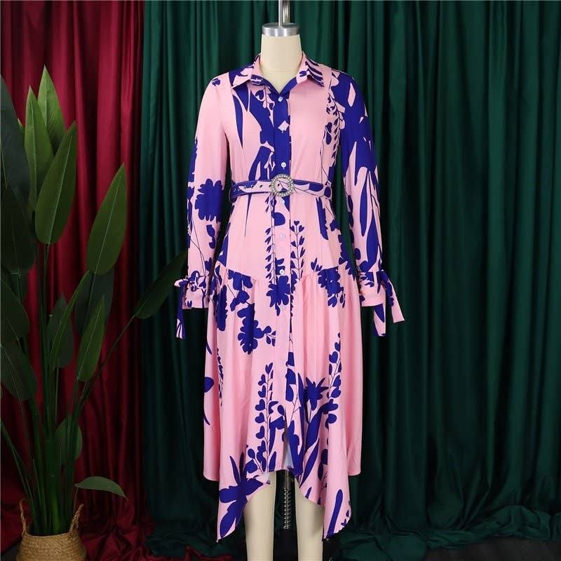 Pink dress with blue floral pattern on a mannequin against a green curtain background