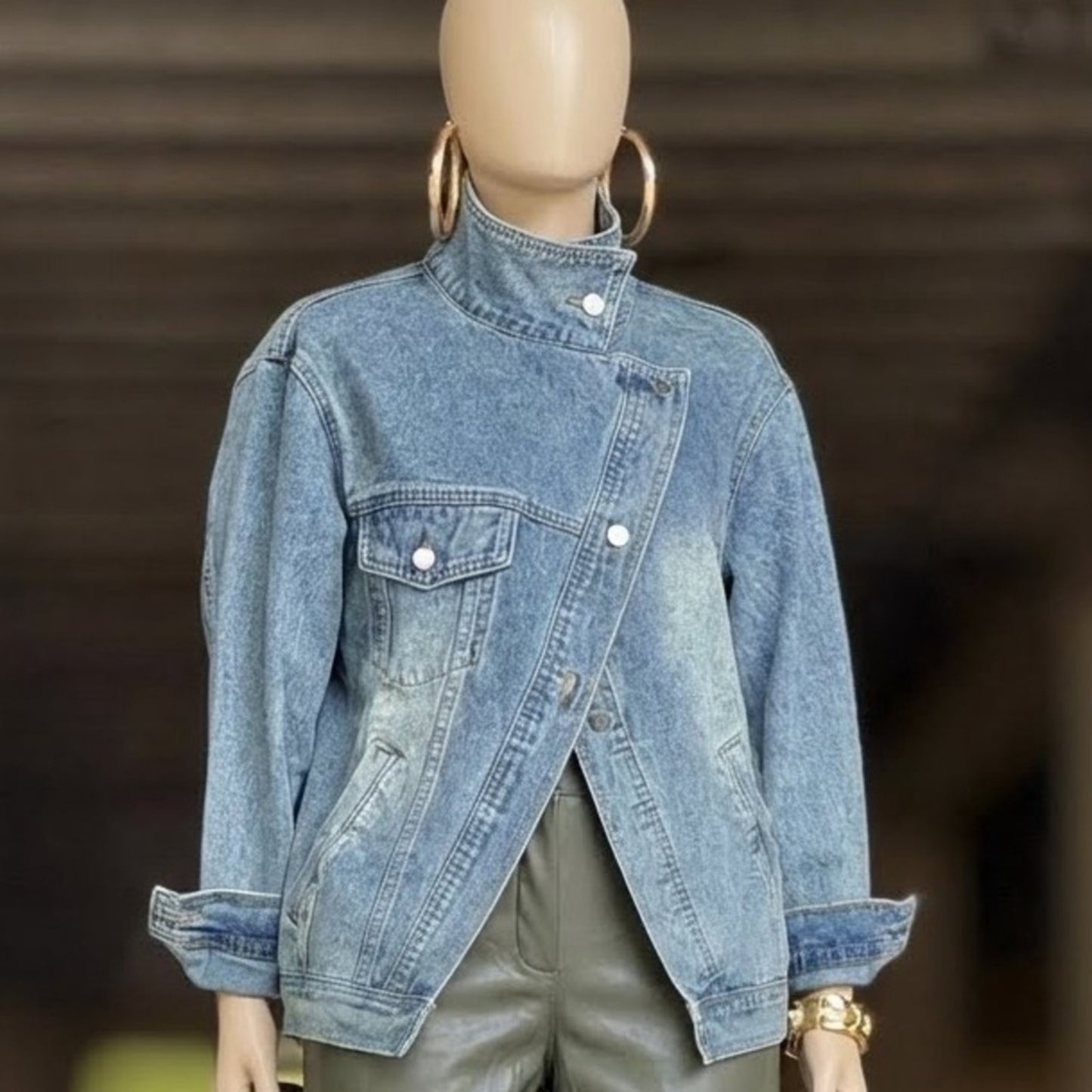 Denim jacket on a mannequin with a blurred background