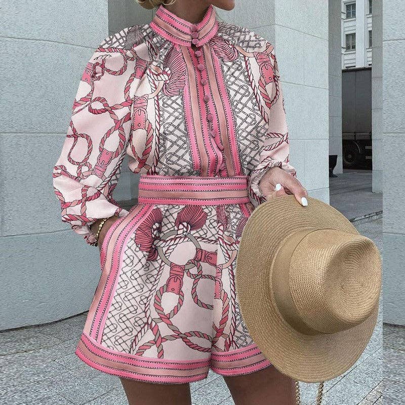 Person wearing a pink and white patterned outfit holding a straw hat.
