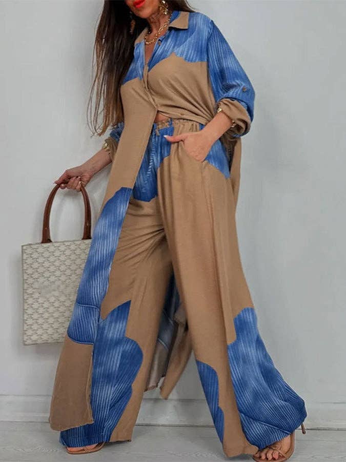 Woman wearing a blue and beige outfit with a handbag against a white background