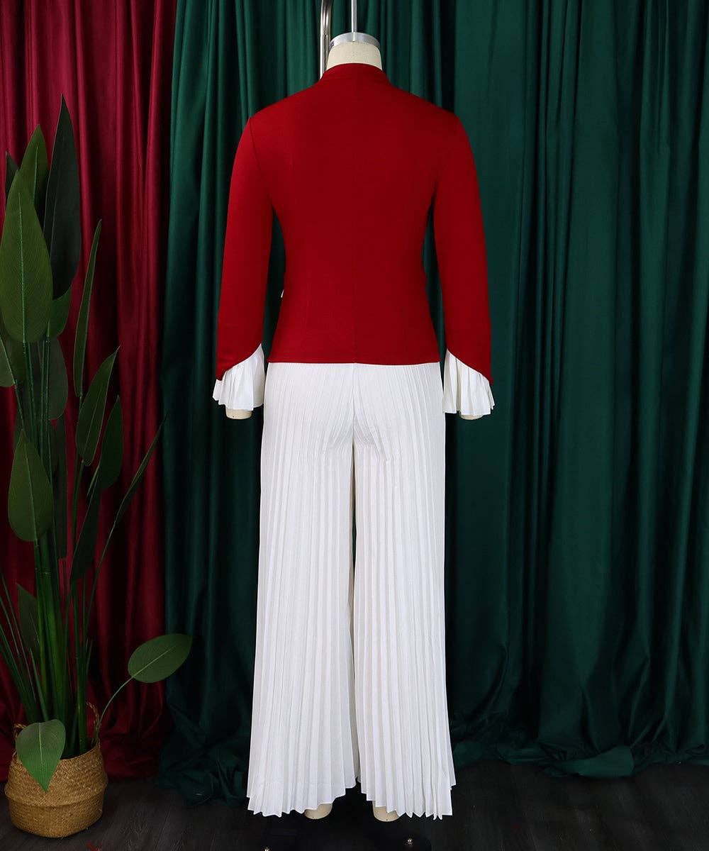 Red jacket and white pleated pants on a mannequin against a green curtain background