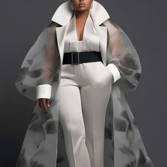 Person wearing a stylish outfit with a white jacket and pants on a dark background