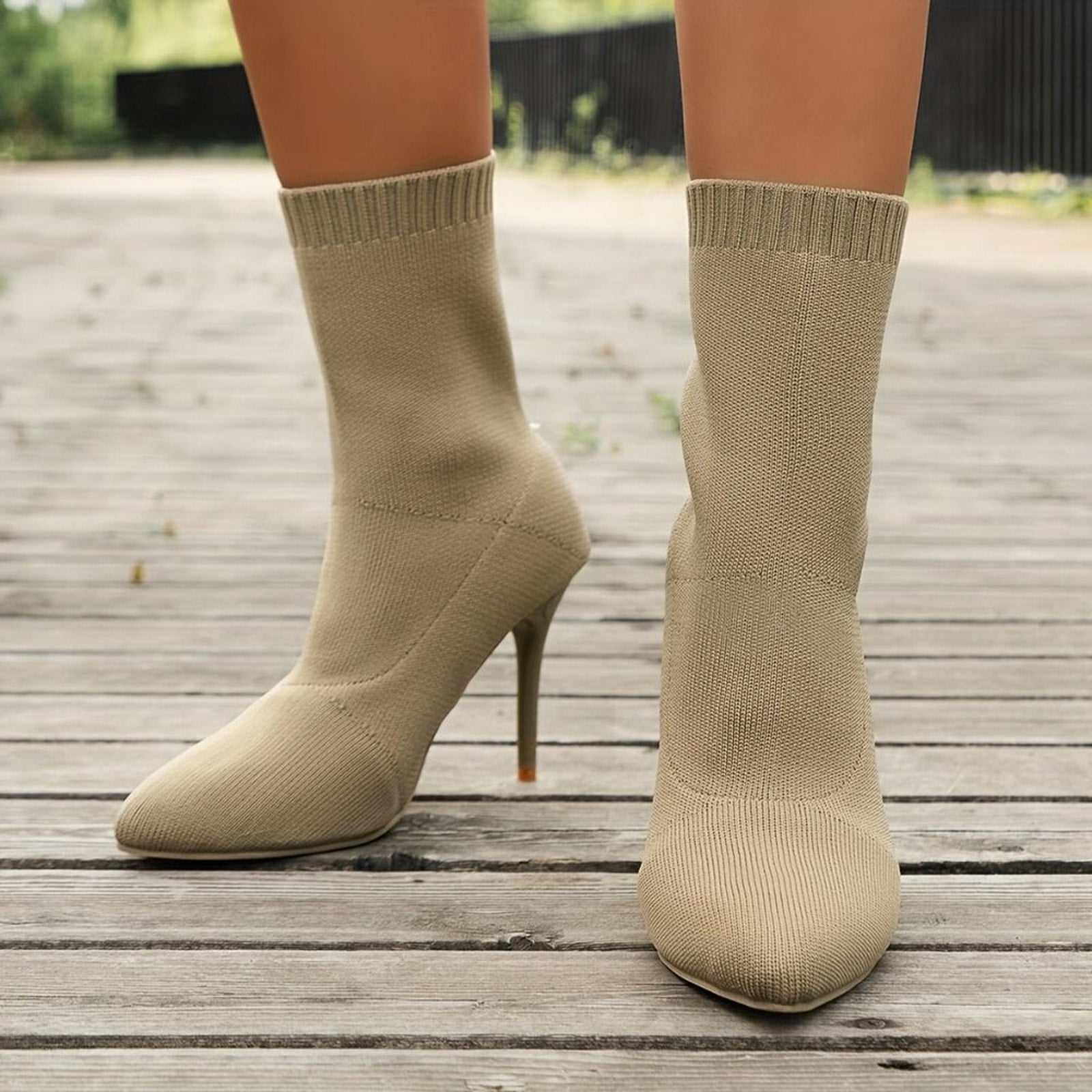 Beige high-heeled socks on a wooden floor