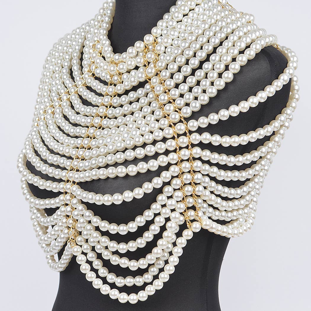 Multiple layers of pearl necklaces on a mannequin against a white background