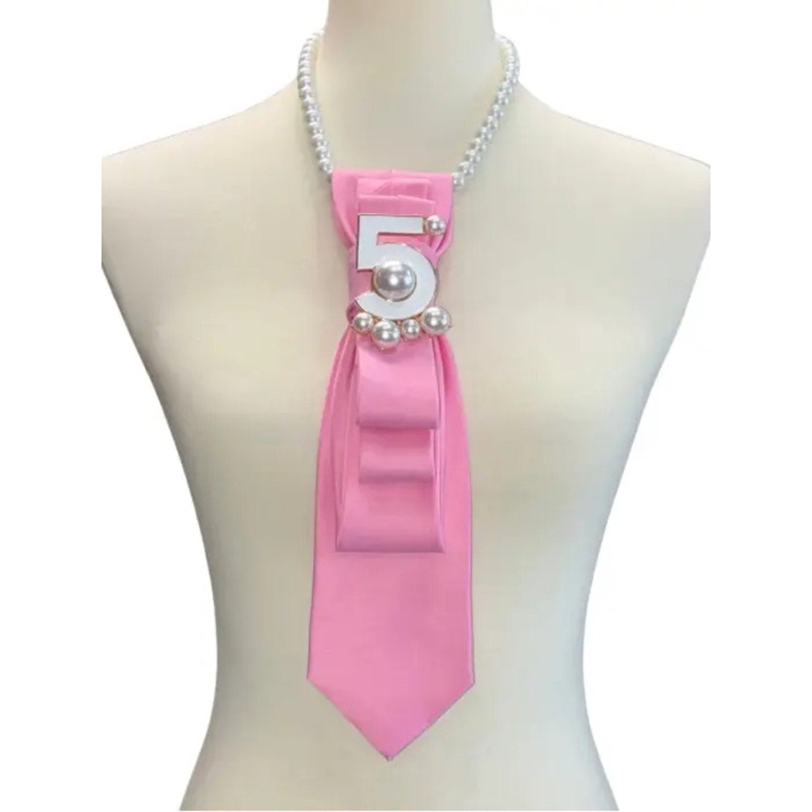 Mannequin wearing a pink ribbon with number 5 and pearls on a white background