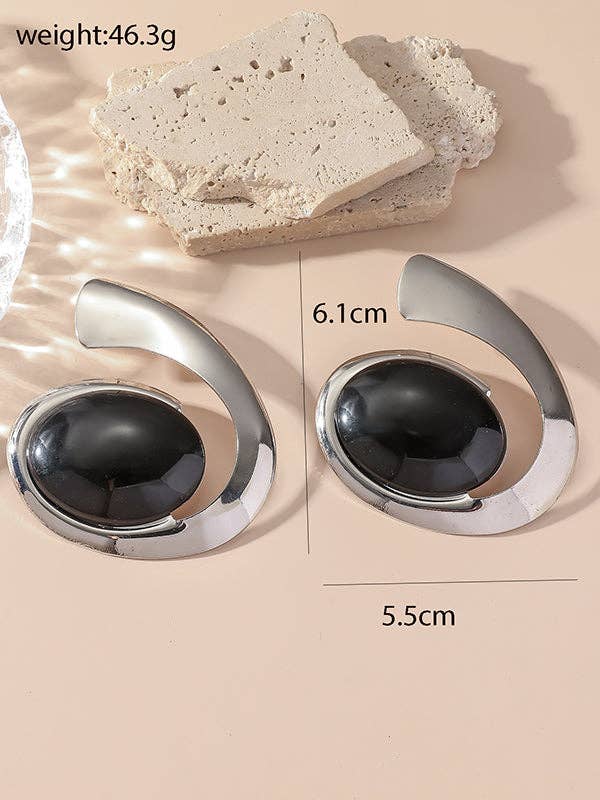 Pair of earrings with black gemstones and silver accents on a beige background, shown with measurements and weight information.
