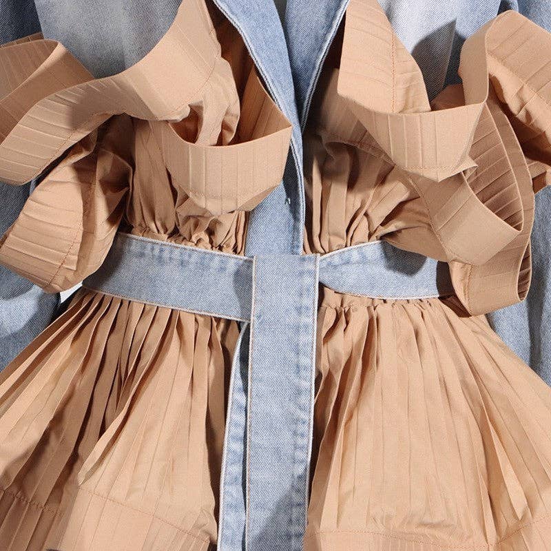 Close-up of a beige dress with a denim belt on a gray background