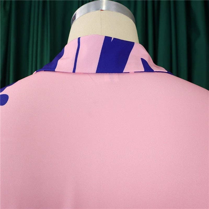 Pink jacket with blue accents on a mannequin against a green curtain background
