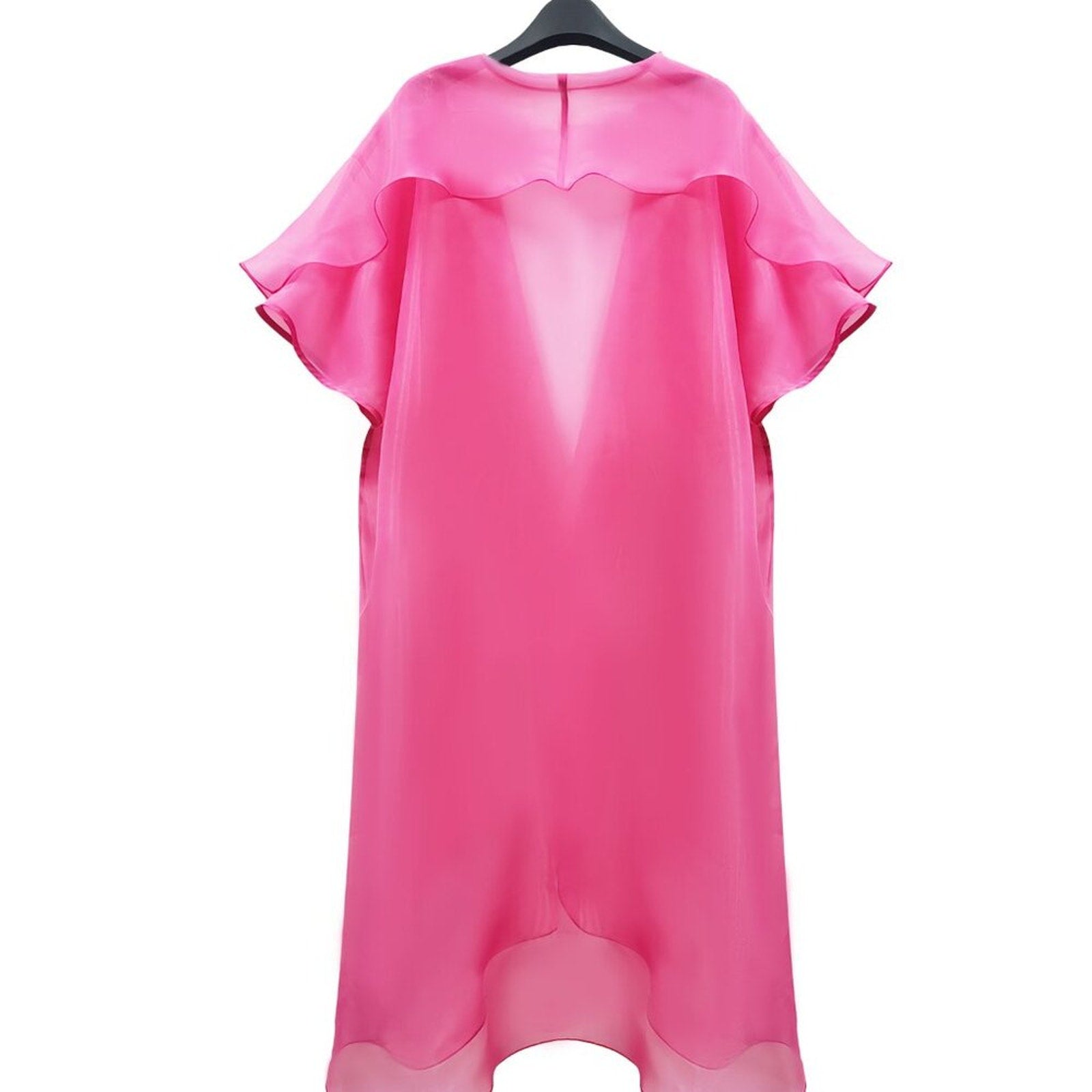 Pink dress on a hanger against a white background