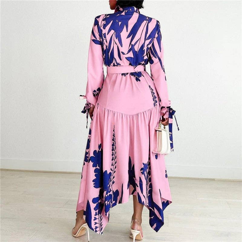 Person wearing a pink dress with blue floral pattern indoors.