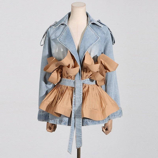 Denim jacket with ruffled beige dress on a mannequin against a light gray background