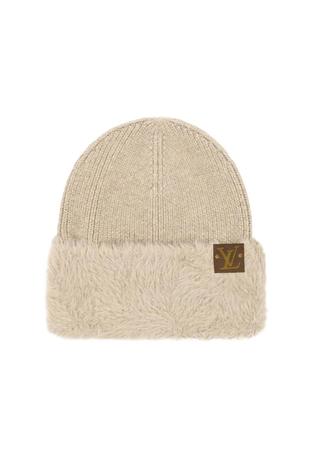 Beige knit beanie with a brand logo on a white background