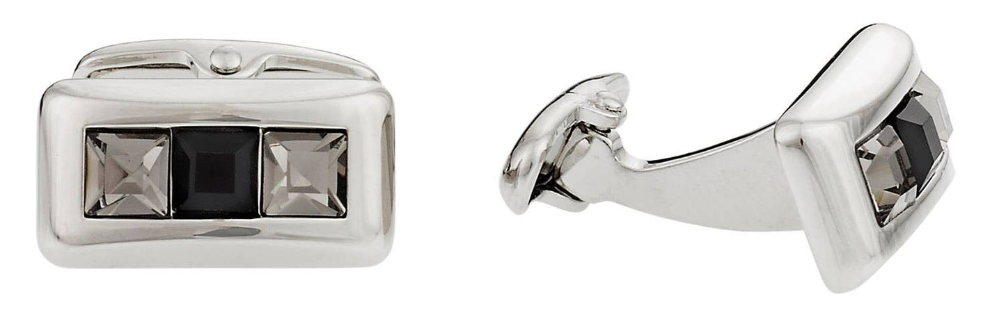 Silver cufflinks with black gemstones on a white background