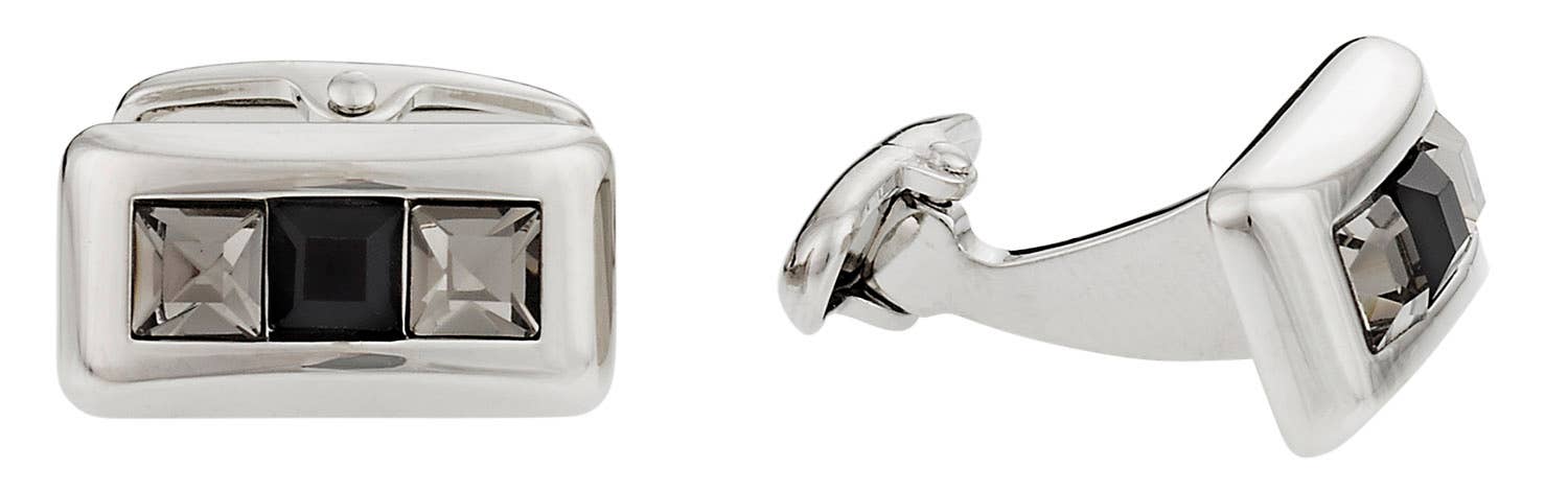 Silver cufflinks with black gemstones on a white background