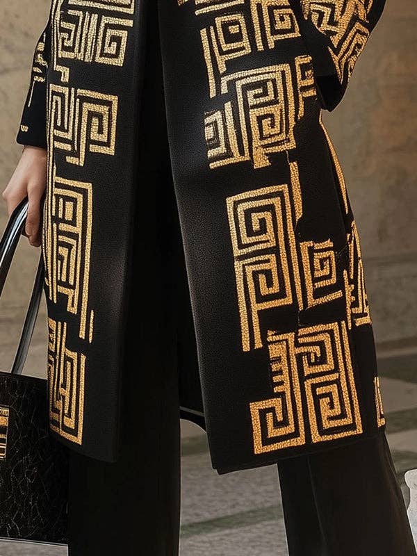 Black coat with gold geometric patterns worn by a person, blurred background