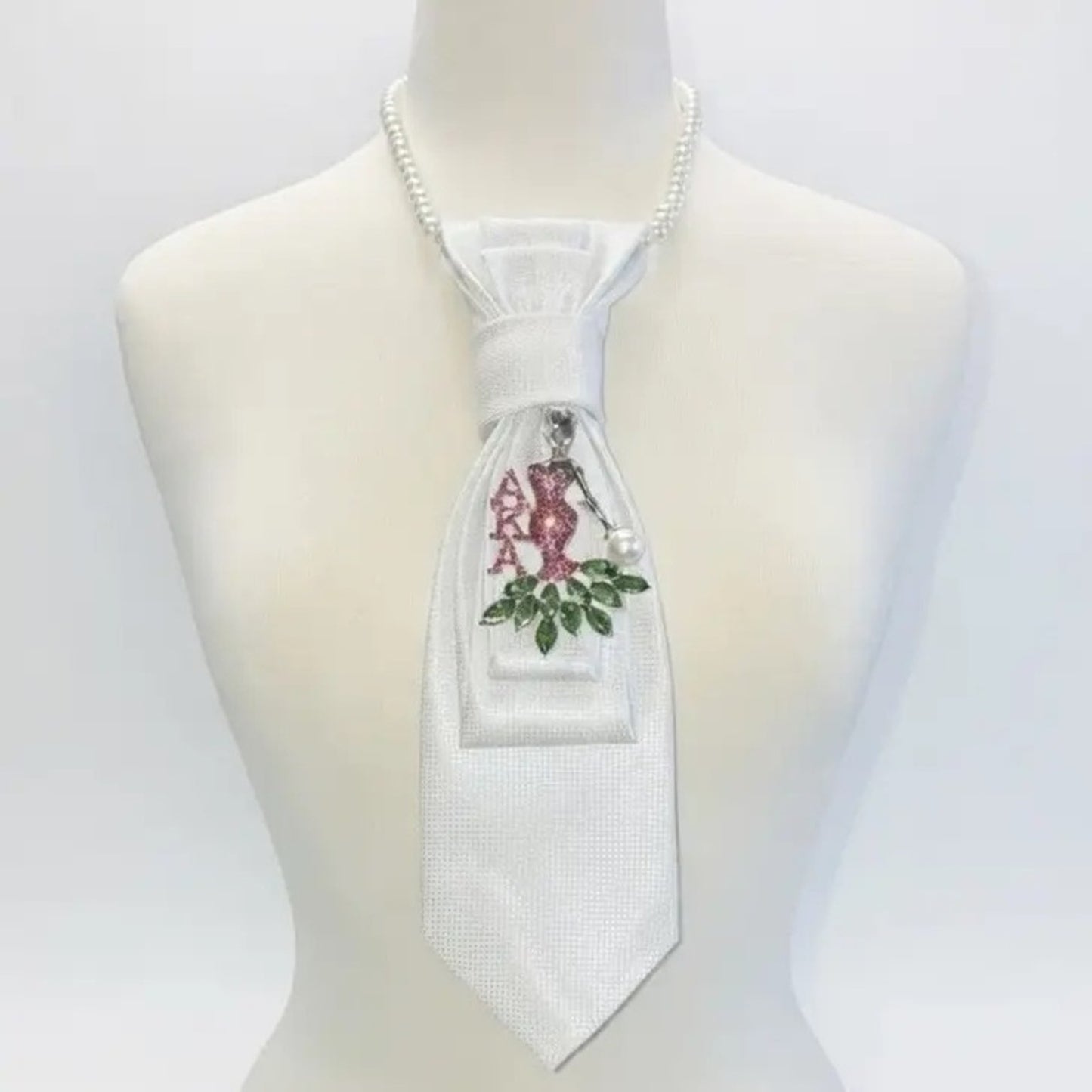 White tie with floral design on a mannequin against a white background