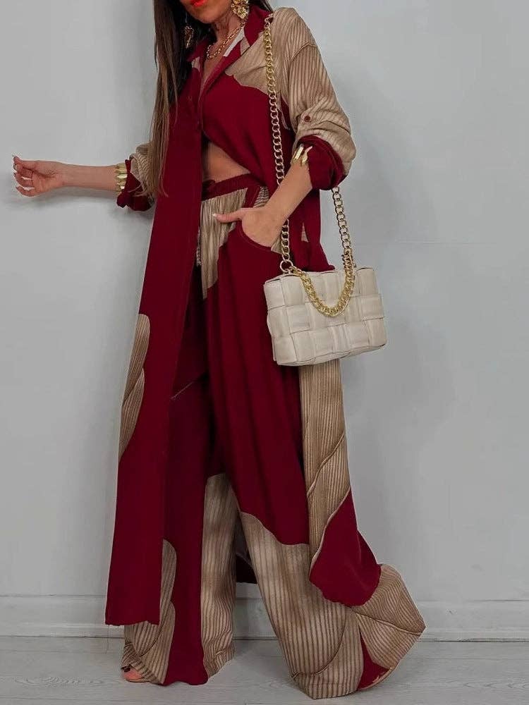 Woman wearing a red and beige outfit with a white handbag against a plain background